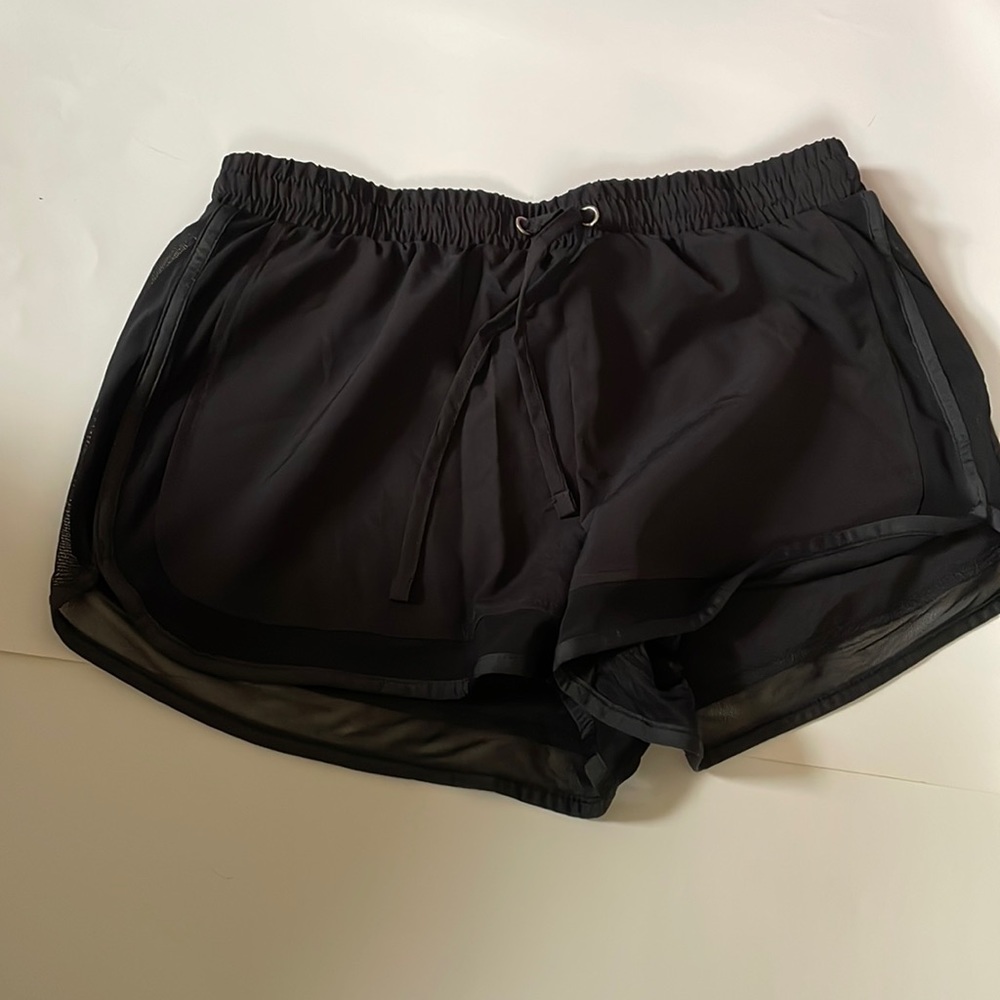 Black swim shorts with sheer edging